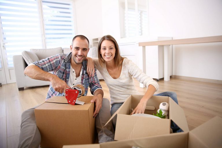 A man and woman are packing boxes for moving to a new home